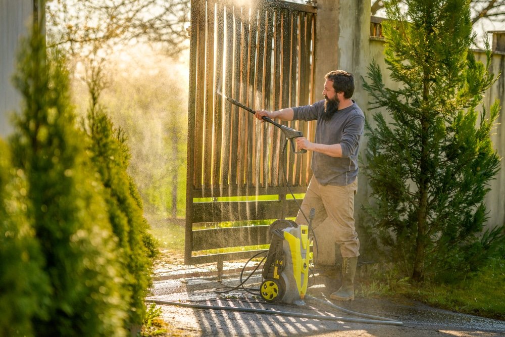 Mid,Adult,Man,Cleaning,A,Wooden,Gate,With,A,Power
